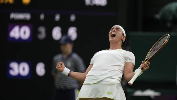 Tunisia's Ons Jabeur celebrates after beating Canada's Bianca Andreescu in a women's singles match on day six of the Wimbledon tennis championships in London, Saturday, July 8, 2023. (AP Photo/Alastair Grant)