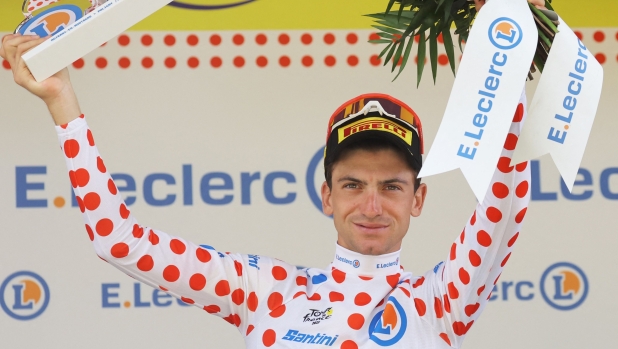 Lidl - Trek's Italian rider Giulio Ciccone celebrates on the podium with the best climber's polka dot (dotted) jersey after the 19th stage of the 110th edition of the Tour de France cycling race 173 km between Moirans-en-Montagne and Poligny, in the Jura department of central-eastern France, on July 21, 2023. (Photo by Thomas SAMSON / AFP)