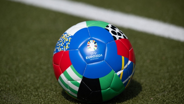 22 June 2023, Hamburg: A soccer ball with the UEFA EURO 2024 logo lies on an artificial turf pitch on the sidelines of a press conference on a UEFA EURO 2024 ideas competition. Photo: Daniel Reinhardt/dpa (Photo by DANIEL REINHARDT / DPA / dpa Picture-Alliance via AFP)