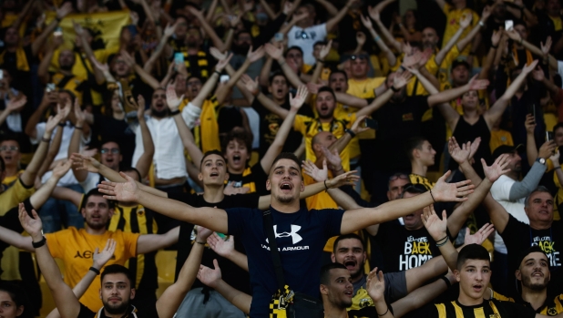 epa10216497 Fans of AEK Athens cheer during the official opening of the OPAP Arena in Nea Filadelfeia, near Athens, Greece, 30 September 2022. The constructions works for the purpose-built stadium began in 2017 at the site of the old Nikos Goumas stadium.  EPA/Yannis Kolesidis