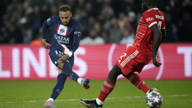 FILE - Bayern's Dayot Upamecano, right, tries to block a shot from PSG's Neymar during the Champions League round of 16 first leg soccer match between Paris Saint Germain and Bayern Munich, at the Parc des Princes stadium, in Paris, France, Tuesday, Feb. 14, 2023. (AP Photo/Christophe Ena, File)