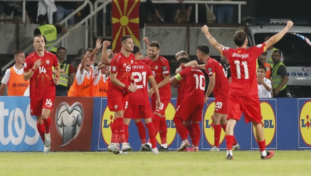 North Macedonia's Enis Bardhi, center, celebrates with his teammates after he scored his side's first goal during the Euro 2024 group C qualifying soccer match between North Macedonia and Italy at National Arena Todor Proeski in Skopje, North Macedonia, Saturday, Sept. 9, 2023. (AP Photo/Boris Grdanoski)