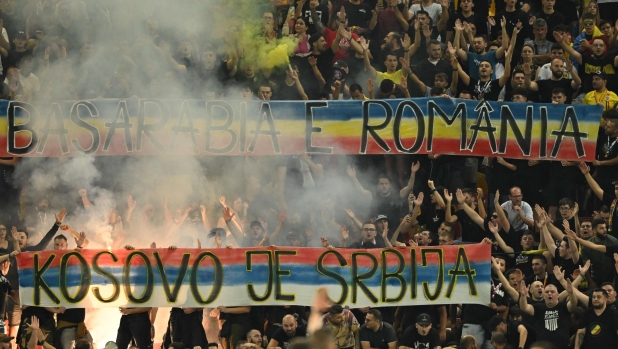 Romanian ultras display banners reading (in Serbian) "Kosovo is Serbia" and (in Romanian) "Bessarabia is Romania" during the EURO 2024 first round group I qualifying football match between Romania and Kosovo in Bucharest on September 12, 2023. (Photo by Daniel MIHAILESCU / AFP)