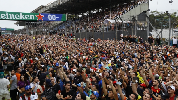 Fans cheer at the end of the Brazilian Formula One Grand Prix at the Interlagos race track in Sao Paulo, Brazil, Sunday, Nov.13, 2022. (AP Photo/Marcelo Chello)