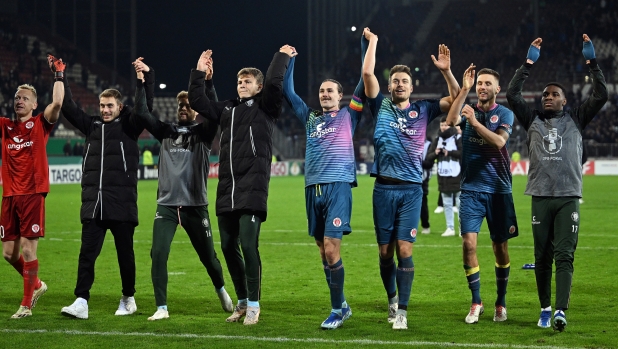 HAMBURG, GERMANY - OCTOBER 31: Players of FC St. Pauli celebrate after the team's victory in the DFB cup second round match between FC St. Pauli and FC Schalke 04 at Millerntor Stadium on October 31, 2023 in Hamburg, Germany. (Photo by Oliver Hardt/Getty Images)