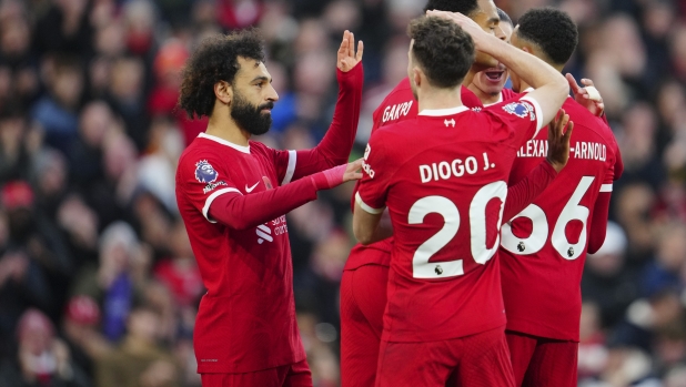 Liverpool's Mohamed Salah is congratulated after scoring his side's opening goal during the English Premier League soccer match between Liverpool and Brentford at Anfield stadium in Liverpool, England, Sunday, Nov. 12, 2023. (AP Photo/Jon Super)