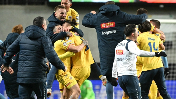 Romania's players celebrate after the UEFA Euro 2024 group I qualification football match between Israel and Romania in Felcsut on November 18, 2023. (Photo by Attila KISBENEDEK / AFP)