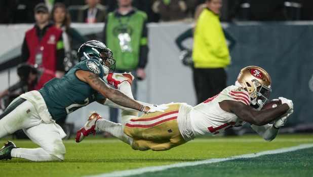 San Francisco 49ers wide receiver Deebo Samuel, right, dives in for a touchdown as Philadelphia Eagles cornerback Darius Slay tries to stop him during the second half of an NFL football game, Sunday, Dec. 3, 2023, in Philadelphia. (AP Photo/Matt Slocum)