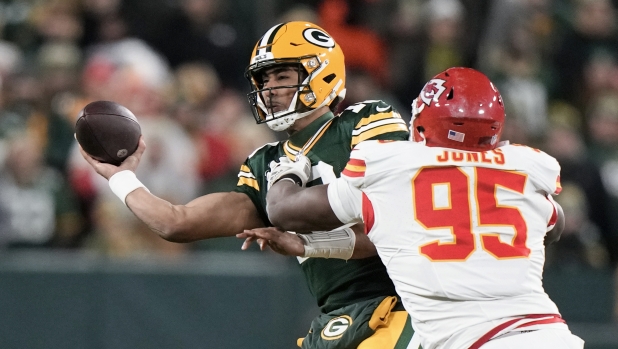 Green Bay Packers quarterback Jordan Love (10) throws under pressure from Kansas City Chiefs defensive tackle Chris Jones (95) during the first half of an NFL football game Sunday, Dec. 3, 2023 in Green Bay, Wis. (AP Photo/Morry Gash)