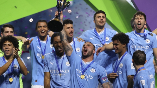 Manchester City's English defender #02 Kyle Walker lifts the trophy after the FIFA Club World Cup final football match between Brazil's Fluminense and England's Manchester City at the King Abdullah Sports City in Jeddah on December 22, 2023. (Photo by AFP)
