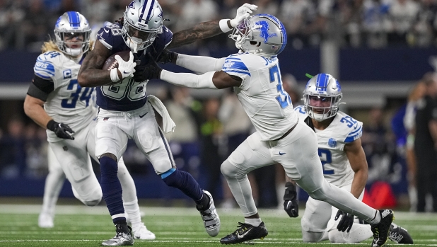Dallas Cowboys wide receiver CeeDee Lamb (88) applies a stiff-arm on Detroit Lions safety Kerby Joseph during the second half of an NFL football game, Saturday, Dec. 30, 2023, in Arlington, Texas. (AP Photo/Sam Hodde)
