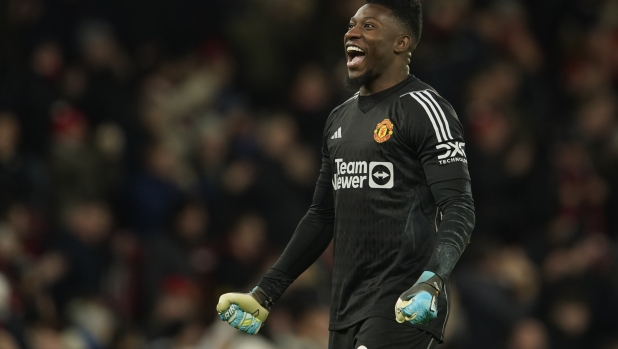 Manchester United's goalkeeper Andre Onana celebrates on the full time during the English Premier League soccer match between Manchester United and Aston Villa at the Old Trafford stadium in Manchester, England, Tuesday, Dec. 26, 2023. Manchester United won 3-2. (AP Photo/Dave Thompson)