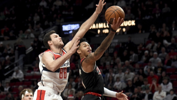 Portland Trail Blazers guard Anfernee Simons, right, drives to the basket against Washington Wizards forward Danilo Gallinari (88) during the first half of an NBA basketball game in Portland, Ore., Thursday, Dec. 21, 2023. (AP Photo/Steve Dykes)