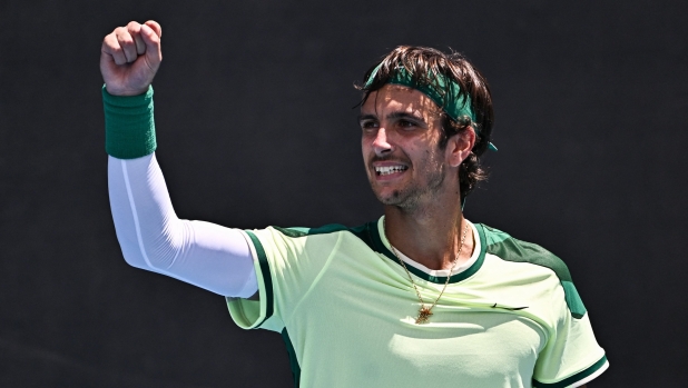 Italy's Lorenzo Musetti celebrates after victory against France's Benjamin Bonzi during their men's singles match on day two of the Australian Open tennis tournament in Melbourne on January 15, 2024. (Photo by Lillian SUWANRUMPHA / AFP) / -- IMAGE RESTRICTED TO EDITORIAL USE - STRICTLY NO COMMERCIAL USE --