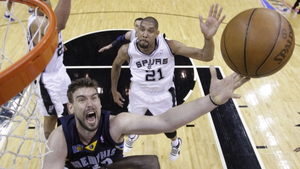 Memphis Grizzlies' Marc Gasol, left, of Spain, shoots as San Antonio Spurs' Tim Duncan (21) looks on during the fourth quarter of Game 2 of a first-round NBA basketball playoff series on Wednesday, April 20, 2011, in San Antonio. (AP Photo/Eric Gay)