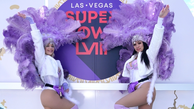 Showgirls Bailey and Kassidy pose for a picture on the Strip ahead of Super Bowl LVIII at Allegiant Stadium in Las Vegas, Nevada on February 9, 2024. The biggest party in American sport is about to get even bigger on February 11, 2024 when Las Vegas hosts the San Francisco 49ers and Kansas City Chiefs in what promises to be a Super Bowl blockbuster for the ages. (Photo by TIMOTHY A. CLARY / AFP)
