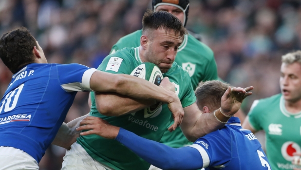 Ireland's Jack Conan, centre is tackled by Italy's Paolo Garbisi, left and Federico Ruzza during a Six Nations rugby union match between Ireland and Italy at the Aviva Stadium in Dublin, Sunday Feb.11, 2024. (AP Photo/Peter Morrison)