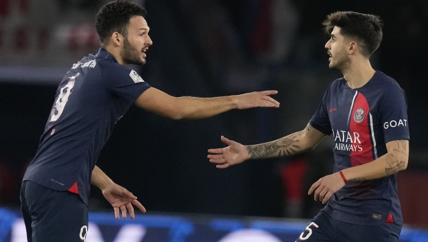 PSG's Goncalo Ramos, left, celebrates with Lucas Beraldo after scoring his side's first goal during the French League One soccer match between Paris Saint-Germain and Lille at the Parc des Princes stadium in Paris, France, Saturday, Feb. 10, 2024. (AP Photo/Thibault Camus)