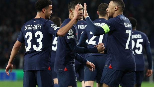 Paris Saint-Germain's French forward #07 Kylian Mbappe celebrates scoring his team's second goal, with teammates, during the UEFA Champions League last 16 second leg football match between Real Sociedad and Paris Saint-Germain (PSG) at the Anoeta stadium in San Sebastian on March 5, 2024. (Photo by FRANCK FIFE / AFP)