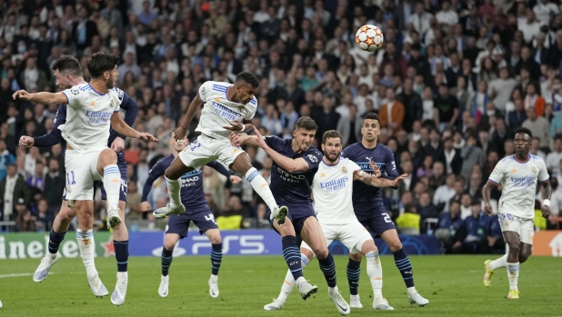 Real Madrid's Rodrygo, third left, scores his side's second goal during the Champions League semi final, second leg, soccer match between Real Madrid and Manchester City at the Santiago Bernabeu stadium in Madrid, Spain, Wednesday, May 4, 2022. (AP Photo/Bernat Armangue)