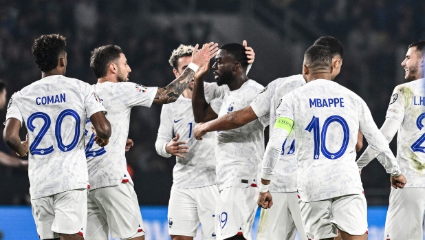France's midfielder #19 Youssouf Fofana (C) celebrates with teammates after scoring his team's second goal during the UEFA Euro 2024 Group B second leg qualifying football match between Greece and France at the Agia Sophia Stadium in Athens on November 21, 2023. (Photo by Aris MESSINIS / AFP)