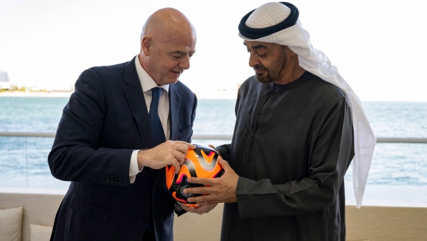 This handout picture provided by the UAE Presidential Court shows President of the United Arab Emirates Mohamed bin Zayed Al Nahyan (R) receiving President of FIFA Gianni Infantino in Abu Dhabi on February 21, 2024. (Photo by Hamad AL-KAABI / UAE PRESIDENTIAL COURT / AFP) / === RESTRICTED TO EDITORIAL USE - MANDATORY CREDIT "AFP PHOTO / UAE PRESIDENTIAL COURT- NO MARKETING NO ADVERTISING CAMPAIGNS - DISTRIBUTED AS A SERVICE TO CLIENTS ===