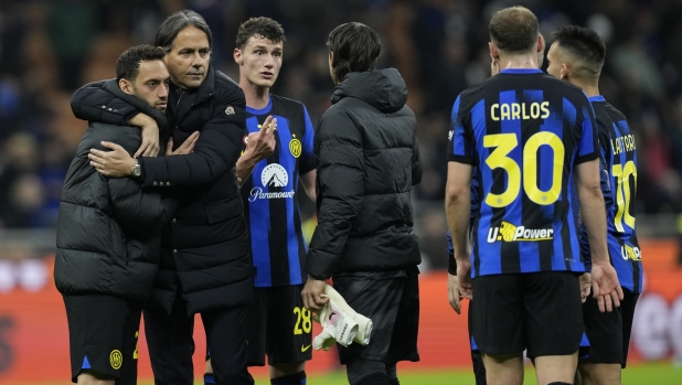 Inter Milan's head coach Simone Inzaghi, second left, embraces his players at full time of the Serie A soccer match between Inter Milan and Empoli at the San Siro Stadium, in Milan, Italy, Monday, April 1, 2024. (AP Photo/Antonio Calanni)