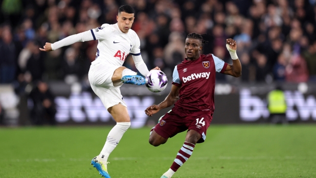 LONDON, ENGLAND - APRIL 02: Pedro Porro of Tottenham Hotspur is challenged by Mohammed Kudus of West Ham United during the Premier League match between West Ham United and Tottenham Hotspur at the London Stadium on April 02, 2024 in London, England. (Photo by Julian Finney/Getty Images)