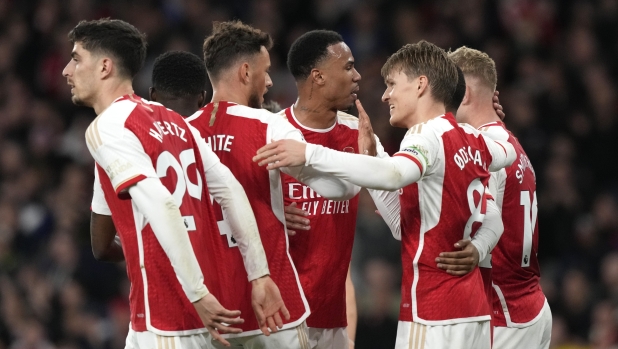 Arsenal players celebrate after Arsenal's Martin Odegaard, second right, scored his side's opening goal during the English Premier League soccer match between Arsenal and Luton Town at the Emirates Stadium, London, Wednesday, Apr. 3, 2024. (AP Photo/Frank Augstein)