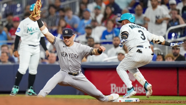 MIAMI, FLORIDA - AUGUST 11: Jake Bauers #61 of the New York Yankees tags out Luis Arraez #3 of the Miami Marlins during the eighth inning at loanDepot park on August 11, 2023 in Miami, Florida.   Rich Storry/Getty Images/AFP (Photo by Rich Storry / GETTY IMAGES NORTH AMERICA / Getty Images via AFP)