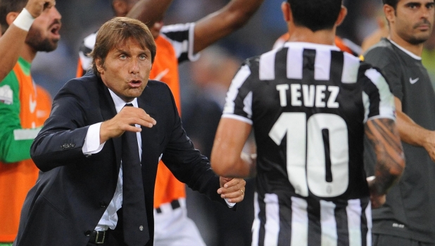 Italian coach of Juventus, Antonio Conte, talks with his Argentinian forward Carlos Tevez during the Italian Supercoppa final soccer match Juventus FC vs SS Lazio at the Olimpico stadium in Rome, Italy, 18 August 2013.
ANSA/MAURIZIO BRAMBATTI