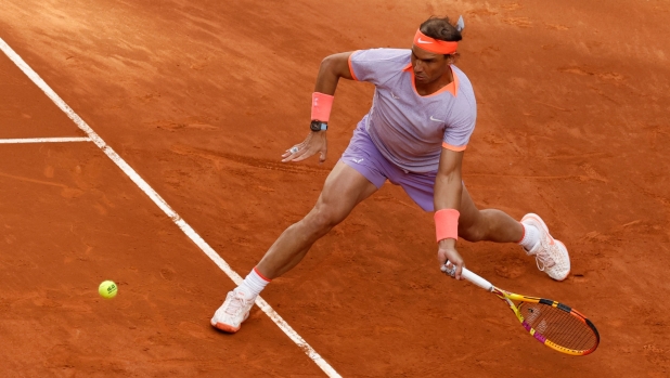 TOPSHOT - Spain's Rafael Nadal returns the ball to US' Darwin Blanch during the 2024 ATP Tour Madrid Open tennis tournament singles match at Caja Magica in Madrid on April 25, 2024. (Photo by OSCAR DEL POZO / AFP)