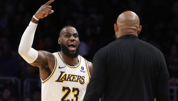 Los Angeles Lakers forward LeBron James, left, asks head coach Darvin Ham for a replay review after he was called for a foul during the second half in Game 4 of an NBA basketball first-round playoff series Saturday, April 27, 2024, in Los Angeles. (AP Photo/Mark J. Terrill)