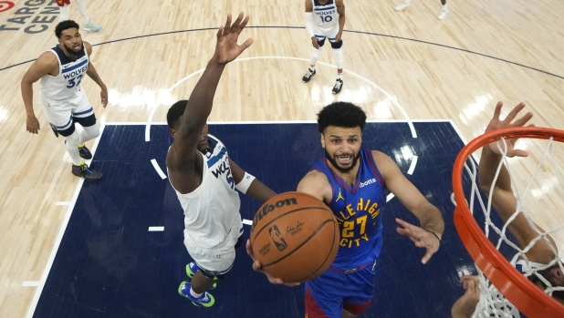 Denver Nuggets guard Jamal Murray (27) goes up for a shot against the Minnesota Timberwolves during the first half of Game 3 of an NBA basketball second-round playoff series Friday, May 10, 2024, in Minneapolis. (AP Photo/Abbie Parr)