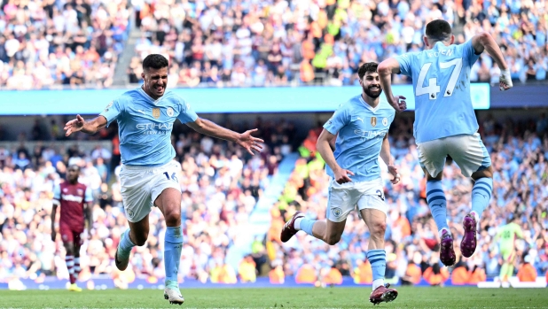 Manchester City's Spanish midfielder #16 Rodri (L) celebrates scoring the team's third goal during the English Premier League football match between Manchester City and West Ham United at the Etihad Stadium in Manchester, north west England, on May 19, 2024. (Photo by Oli SCARFF / AFP) / RESTRICTED TO EDITORIAL USE. No use with unauthorized audio, video, data, fixture lists, club/league logos or 'live' services. Online in-match use limited to 120 images. An additional 40 images may be used in extra time. No video emulation. Social media in-match use limited to 120 images. An additional 40 images may be used in extra time. No use in betting publications, games or single club/league/player publications. /