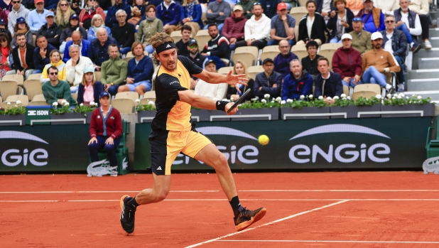 Greece's Stefanos Tsitsipas plays a shot against Hungary's Marton Fucsovics during their first round match of the French Open tennis tournament at the Roland Garros stadium in Paris, Monday, May 27, 2024. (AP Photo/Aurelien Morissard)