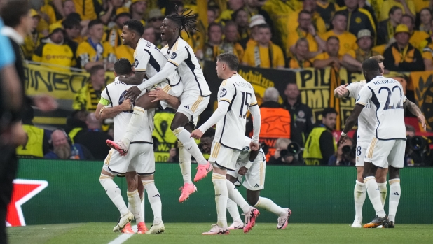Real Madrid players celebrate their side's first foal scored by Dani Carvajal during the Champions League final soccer match between Borussia Dortmund and Real Madrid at Wembley stadium in London, Saturday, June 1, 2024. (AP Photo/Kirsty Wigglesworth)
