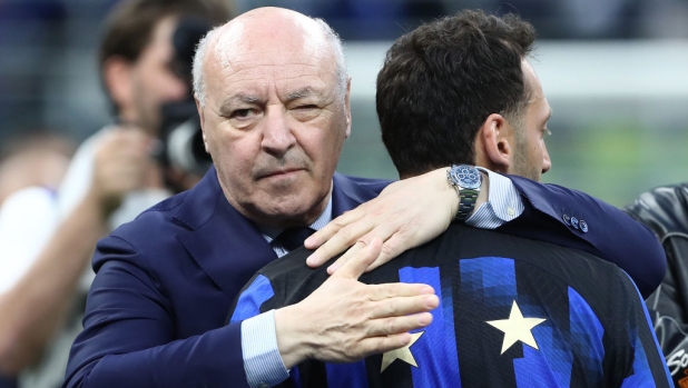 MILAN, ITALY - MAY 19: Giuseppe Marotta, CEO of FC Internazionale, embraces Hakan Calhanoglu of FC Internazionale during the Serie A TIM Scudetto title trophy presentation at full-time following the team's draw in the Serie A TIM match between FC Internazionale and SS Lazio at Stadio Giuseppe Meazza on May 19, 2024 in Milan, Italy. (Photo by Marco Luzzani/Getty Images)