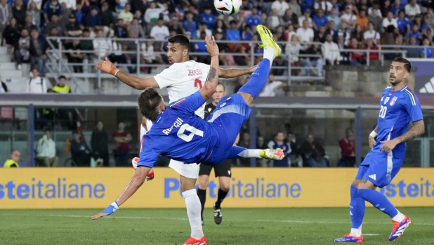 Italy's Mateo Retegui, front, attempts a shot on goal during the international friendly soccer match between Italy and Turkey at the Renato Dall'Ara stadium in Bologna, Italy, Tuesday, June 4, 2024. (AP Photo/Antonio Calanni)