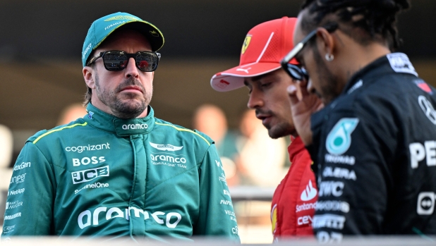 Aston Martin's Spanish driver Fernando Alonso (L), Ferrari's Monegasque driver Charles Leclerc (C) and Mercedes' British driver Lewis Hamilton attend the drivers' parade before the start of the Bahrain Formula One Grand Prix at the Bahrain International Circuit in Sakhir on March 2, 2024. (Photo by ANDREJ ISAKOVIC / AFP)