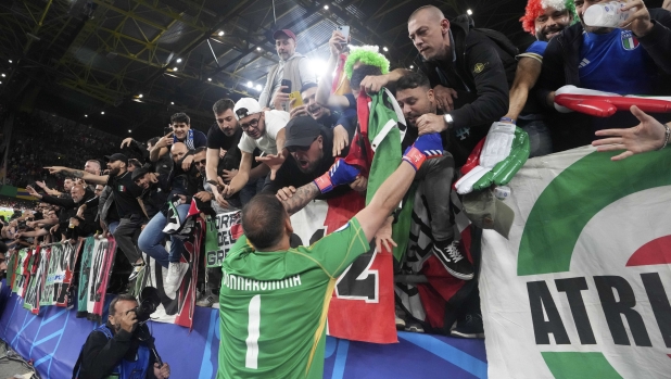 Italy's goalkeeper Gianluigi Donnarumma celebrates with fans at the end of the Group B match between Italy and Albania at the Euro 2024 soccer tournament in Dortmund, Germany, Saturday, June 15, 2024. Italy won the match 2-1. (AP Photo/Martin Meissner)