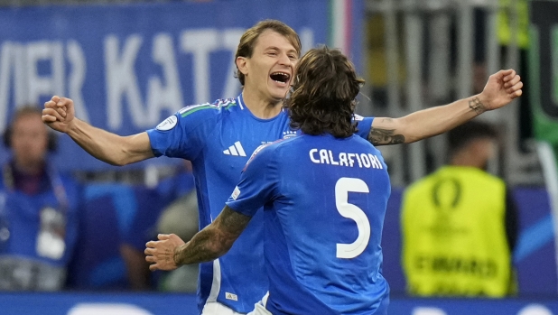 Italy's Nicolo Barella, left, celebrates with his teammate Riccardo Calafiori after scoring his side's second goal during a Group B match between Italy and Albania at the Euro 2024 soccer tournament in Dortmund, Germany, Saturday, June 15, 2024. (AP Photo/Alessandra Tarantino)