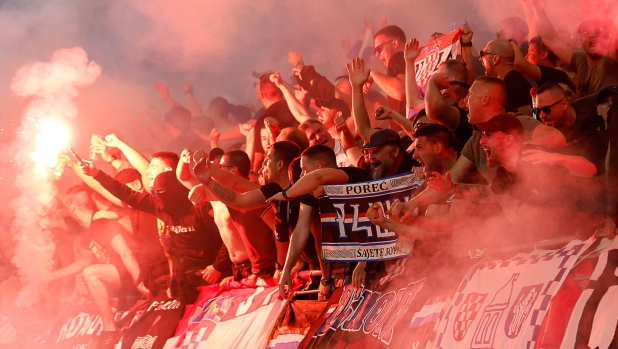 Supporters of Croatia celebrate after their team's first goal with flares during the UEFA Euro 2024 Group B football match between Croatia and Italy at the Leipzig Stadium in Leipzig on June 24, 2024. (Photo by Odd ANDERSEN / AFP)