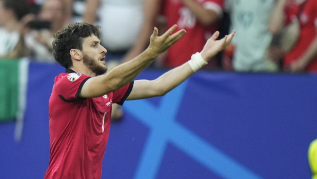 Georgia's Khvicha Kvaratskhelia celebrates after scoring his side's first goal during a Group F match between Georgia and Portugal at the Euro 2024 soccer tournament in Gelsenkirchen, Germany, Wednesday, June 26, 2024. (AP Photo/Alessandra Tarantino)