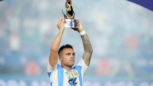 Argentina's Lautaro Martínez celebrates with the Golden Boot trophy after defeating Colombia in the Copa America final soccer match in Miami Gardens, Fla., Monday, July 15, 2024. (AP Photo/Julio Cortez)