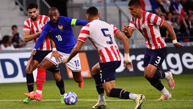 France's forward #10 Alexandre Lacazette (2nd-L) runs with the ball during the U23 friendly football match between France and Paraguay at Jean Dauger stadium in Bayonne, southwestern France, on July 4, 2024, in preparation for the Paris 2024 Olympic Games. (Photo by GAIZKA IROZ / AFP)