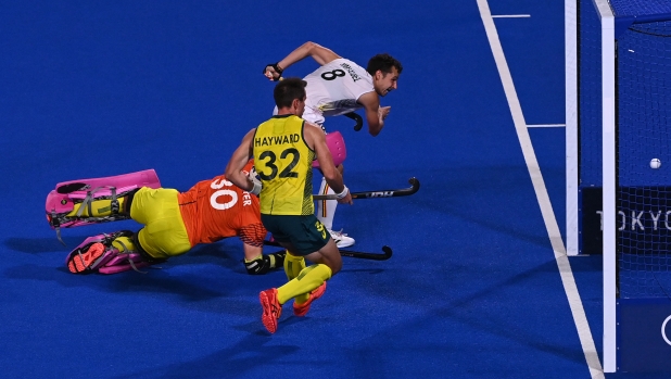 elgium's Florent Van Aubel (top) scores past Australia's goalkeeper Andrew Lewis Charter during the men's gold medal match of the Tokyo 2020 Olympic Games field hockey competition, at the Oi Hockey Stadium in Tokyo, on August 5, 2021. (Photo by Tauseef MUSTAFA / AFP)