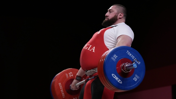 FILE - Lasha Talakhadze of Georgia competes in the men's +109kg weightlifting event, at the 2020 Summer Olympics, Wednesday, Aug. 4, 2021, in Tokyo, Japan. (AP Photo/Luca Bruno, File)