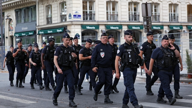 epa11497287 French police forces patrol ahead of the Opening Ceremony of the Paris 2024 Olympic Games, in Paris, France, 26 July 2024.  EPA/MOHAMMED BADRA