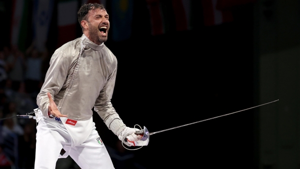 epa11500805 Luigi Samele of Italy celebrates after winning the Men Sabre Individual bronze medal bout against Ziad Elsissy of Egypt in the Paris 2024 Olympic Games, at the Grand Palais in Paris, France, 27 July 2024.  EPA/RITCHIE B. TONGO